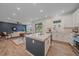 Open-concept kitchen flowing into the living area, with a large island, stainless appliances, and hardwood flooring at 8268 Mt Harvard Rd, Littleton, CO 80125