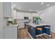 Bright kitchen featuring white cabinetry, stainless steel appliances, and a center island with bar stool seating at 8268 Mt Harvard Rd, Littleton, CO 80125