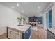 Open-concept living space that leads to a kitchen island with seating at 8268 Mt Harvard Rd, Littleton, CO 80125