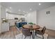 Eat-in kitchen features white cabinets, stainless appliances, a center island, and a round table with four chairs at 8268 Mt Harvard Rd, Littleton, CO 80125