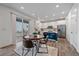 Bright kitchen with white cabinets, stainless appliances, a blue island, and a dining area with sliding glass doors at 8268 Mt Harvard Rd, Littleton, CO 80125