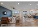 Open-concept living room featuring wood floors, a contemporary ceiling fan, and a stylish accent wall at 8268 Mt Harvard Rd, Littleton, CO 80125