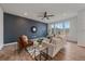 Bright living room with hardwood floors, a modern ceiling fan, comfortable seating, and plenty of natural light at 8268 Mt Harvard Rd, Littleton, CO 80125