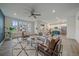 Open-concept living room showcasing stylish furniture, a ceiling fan, large windows, and a view of the kitchen at 8268 Mt Harvard Rd, Littleton, CO 80125