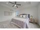 Spacious main bedroom with neutral decor, a tray ceiling, ceiling fan, and plenty of natural light at 8268 Mt Harvard Rd, Littleton, CO 80125