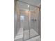 Tiled shower featuring glass doors, built-in bench, tiled walls, and modern fixtures at 8268 Mt Harvard Rd, Littleton, CO 80125