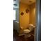 Half bathroom with wood floors adjacent to a laundry room with washer and dryer at 9616 Nucla St, Commerce City, CO 80022