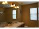 Bathroom featuring a soaking tub and a dual sink vanity beneath a large mirror at 9616 Nucla St, Commerce City, CO 80022