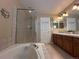 Bathroom featuring a soaking tub, a large shower, and a dual sink vanity at 9616 Nucla St, Commerce City, CO 80022