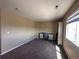 Bedroom featuring neutral paint, carpeted floors, a window, and a desk at 9616 Nucla St, Commerce City, CO 80022