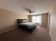 Bedroom with a large bed, neutral carpet and paint, and natural light from the window at 9616 Nucla St, Commerce City, CO 80022