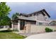 Charming two-story home with a three car garage, fence and a well-manicured front lawn at 9616 Nucla St, Commerce City, CO 80022