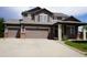 Charming two-story home with a three car garage and a well-manicured front lawn at 9616 Nucla St, Commerce City, CO 80022