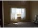 A living room with neutral walls, carpet flooring, art, a window with sheer curtains and furniture at 9616 Nucla St, Commerce City, CO 80022