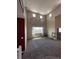A living room with neutral walls, carpet flooring, art, a window with sheer curtains and furniture at 9616 Nucla St, Commerce City, CO 80022