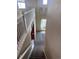 Staircase with neutral walls and carpet, transitioning to the home's lower level at 9616 Nucla St, Commerce City, CO 80022