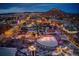 Nighttime aerial view of a charming town square adorned with festive holiday lights and decorations at 3744 Celestial Ave, Castle Rock, CO 80109