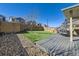Landscaped backyard featuring a well maintained deck, artificial turf and a privacy fence at 3744 Celestial Ave, Castle Rock, CO 80109