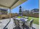 Relaxing backyard patio with ample seating and outdoor umbrella on a well maintained turf lawn at 3744 Celestial Ave, Castle Rock, CO 80109