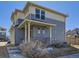Inviting two-story home featuring a covered porch and a blend of gray and beige siding at 3744 Celestial Ave, Castle Rock, CO 80109
