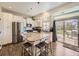 Bright kitchen featuring a center island with seating and stainless steel appliances with backyard access at 3744 Celestial Ave, Castle Rock, CO 80109