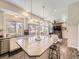 Open-concept kitchen featuring an island, stainless steel appliances, and seamless flow into the living room and outdoor patio at 3744 Celestial Ave, Castle Rock, CO 80109