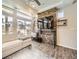 Cozy living space featuring a stone accent wall with a modern entertainment center and ample natural light at 3744 Celestial Ave, Castle Rock, CO 80109