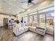 Open-concept living area with a spacious sofa, large windows, and a view of the backyard at 3744 Celestial Ave, Castle Rock, CO 80109