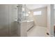Modern bathroom with large grey tile shower and glass door with double sink vanity at 10557 Eby Cir, Lone Tree, CO 80124