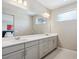 Well-lit bathroom features double sinks, a large mirror, and a window for natural light at 10557 Eby Cir, Lone Tree, CO 80124