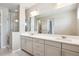 Beautiful bathroom with a large mirror, double sink vanity, and glass shower at 10557 Eby Cir, Lone Tree, CO 80124