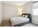 Bedroom with neutral walls, carpet flooring, and a bed with two pillows at 10557 Eby Cir, Lone Tree, CO 80124