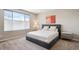 Bright bedroom featuring a comfortable bed, modern accents, and a large window at 10557 Eby Cir, Lone Tree, CO 80124