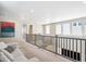 Hallway features sofa, railing, and windows at 10557 Eby Cir, Lone Tree, CO 80124