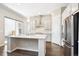 Modern kitchen featuring white cabinets, stainless steel appliances, and an island with a white countertop at 10557 Eby Cir, Lone Tree, CO 80124