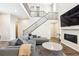Cozy living room featuring a modern fireplace and staircase leading to the second floor at 10557 Eby Cir, Lone Tree, CO 80124