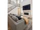 Living room featuring a cozy fireplace, open floor plan, and staircase to the upper level at 10557 Eby Cir, Lone Tree, CO 80124