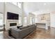 Living room featuring a fireplace, modern kitchen, open layout, and high ceilings at 10557 Eby Cir, Lone Tree, CO 80124