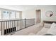 A cozy living room with a gray railing and neutral colors at 10557 Eby Cir, Lone Tree, CO 80124