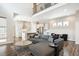 Bright, open-concept living room with a modern sectional sofa adjacent to the kitchen with stainless steel appliances at 10557 Eby Cir, Lone Tree, CO 80124