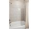 Close up of the bathroom shower-tub featuring tiled walls and a shower curtain at 10557 Eby Cir, Lone Tree, CO 80124