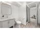 Bright bathroom featuring tile floors, a modern vanity, and a glass-enclosed shower with an open door to another room at 11896 W 107Th Ave, Westminster, CO 80021