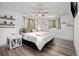 Primary bedroom with hardwood floors, a ceiling fan, and shelves for decorations at 11896 W 107Th Ave, Westminster, CO 80021