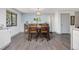 Dining room with hardwood floors, wooden table and chairs and light blue accent wall with buffet at 11896 W 107Th Ave, Westminster, CO 80021