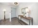 Bright entryway featuring wood floors, stylish console table, mirror, and a contemporary light fixture at 11896 W 107Th Ave, Westminster, CO 80021