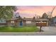 Charming ranch-style home featuring a brick exterior, blue door, manicured lawn and an attached garage at 11896 W 107Th Ave, Westminster, CO 80021