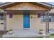 Close-up of the front porch, showcasing a blue front door and decorative hanging flower baskets at 11896 W 107Th Ave, Westminster, CO 80021