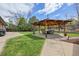 Backyard with an inviting gazebo perfect for outdoor entertaining, a green lawn, and beautiful landscaping at 11896 W 107Th Ave, Westminster, CO 80021