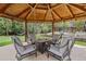 Covered gazebo with comfortable chairs and a fire pit, set in a peaceful landscaped backyard at 11896 W 107Th Ave, Westminster, CO 80021