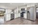 Stylish open kitchen with modern appliances, countertop seating and view into the living room at 11896 W 107Th Ave, Westminster, CO 80021